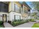 Exterior view of a two-story townhome with a walkway and landscaping at 610 Celebration Ave # 1209, Celebration, FL 34747
