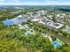 Aerial view of community with lake, tennis courts, and town center at 610 Celebration Ave # 1209, Celebration, FL 34747