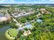 Aerial view of community featuring a pool, tennis courts, playground, and lake at 610 Celebration Ave # 1209, Celebration, FL 34747
