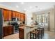 Kitchen with wood cabinets, granite countertops, and island with seating at 610 Celebration Ave # 1209, Celebration, FL 34747