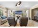 Relaxing living room with two leather recliners, a large TV, and access to a balcony at 610 Celebration Ave # 1209, Celebration, FL 34747