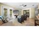 Spacious living area with a large TV, comfortable seating, and access to a balcony at 610 Celebration Ave # 1209, Celebration, FL 34747