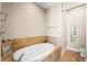 Oval soaking tub, tile surround, and neutral color palette at 610 Celebration Ave # 1209, Celebration, FL 34747