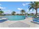 Community pool with plenty of lounge chairs and palm trees at 1687 Badger Creek Rd, Kissimmee, FL 34744