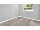 Simple bedroom with gray walls and wood-look flooring at 1002 Ursula St, Ocoee, FL 34761