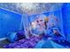 Frozen-themed bedroom with two twin beds, a mural, and canopy beds at 1435 Moon Valley Dr, Davenport, FL 33896