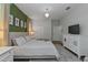 King-size bed, green accent wall, and large white dresser at 1435 Moon Valley Dr, Davenport, FL 33896