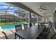 Covered patio with a large table, pool, and grill at 1435 Moon Valley Dr, Davenport, FL 33896