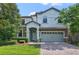 Two-story home with gray siding and brick driveway at 1435 Moon Valley Dr, Davenport, FL 33896