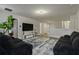 Bright living area with two sofas, a large TV and access to other rooms at 1435 Moon Valley Dr, Davenport, FL 33896