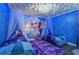 Frozen-themed bedroom with two twin beds, a mural, and canopy beds at 1435 Moon Valley Dr, Davenport, FL 33896