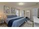 King bedroom with blue bedding, and an ensuite bathroom at 1435 Moon Valley Dr, Davenport, FL 33896