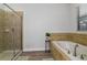 Bathroom with soaking tub, walk-in shower, and tile flooring at 1435 Moon Valley Dr, Davenport, FL 33896