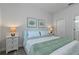 Bedroom with a queen bed, neutral decor, and convenient storage at 1435 Moon Valley Dr, Davenport, FL 33896