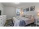 King bedroom with gray bedding, a dresser, and wall art at 1435 Moon Valley Dr, Davenport, FL 33896