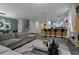 Open living space with sectional sofa and kitchen view at 1435 Moon Valley Dr, Davenport, FL 33896