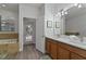 Double vanity bathroom with walk-in shower and garden access at 1435 Moon Valley Dr, Davenport, FL 33896