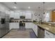 Modern kitchen with white cabinets and granite counters at 1435 Moon Valley Dr, Davenport, FL 33896