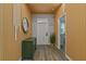 Modern entryway with wood wall and green cabinet at 1435 Moon Valley Dr, Davenport, FL 33896