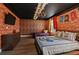 Harry Potter themed bedroom with twin and full-size beds, brick feature wall, and decorative wall hangings at 1435 Moon Valley Dr, Davenport, FL 33896