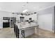 Open kitchen with large island, white cabinets, and granite countertops at 900 Sussex Close, Orlando, FL 32804
