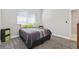 Simple bedroom with a bed, window coverings, and grey carpet at 900 Sussex Close, Orlando, FL 32804