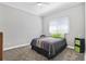 Cozy bedroom with a bed, window coverings, and grey carpet at 900 Sussex Close, Orlando, FL 32804