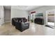 Spacious living room with leather furniture and tile floors at 900 Sussex Close, Orlando, FL 32804