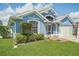 Blue house with two car garage and landscaped yard at 106 Haversham Way, Davenport, FL 33897