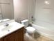 Clean bathroom with tub, toilet and vanity at 963 N Jacks Lake Rd, Clermont, FL 34711