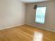 Bright bedroom with wood flooring and large window at 963 N Jacks Lake Rd, Clermont, FL 34711