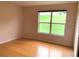 Spacious bedroom with wood flooring and backyard view at 963 N Jacks Lake Rd, Clermont, FL 34711