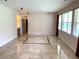 Living room features travertine tile floor and neutral color palette at 963 N Jacks Lake Rd, Clermont, FL 34711