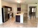 Kitchen with dark wood cabinets, island, and stainless steel appliances at 963 N Jacks Lake Rd, Clermont, FL 34711
