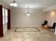 Spacious dining area featuring tile floors and a modern chandelier at 963 N Jacks Lake Rd, Clermont, FL 34711