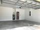 Attached garage with concrete floor and water heater at 963 N Jacks Lake Rd, Clermont, FL 34711