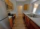 Galley kitchen with stainless steel appliances and wood cabinets at 4881 Cypress Woods Dr # 3213, Orlando, FL 32811