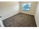 Simple carpeted bedroom with window at 4881 Cypress Woods Dr # 3213, Orlando, FL 32811