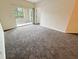 Bright living room with carpet flooring and access to a private balcony at 4881 Cypress Woods Dr # 3213, Orlando, FL 32811