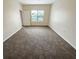 Spacious bedroom with neutral carpeting and large window at 4881 Cypress Woods Dr # 3213, Orlando, FL 32811