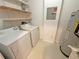 Laundry area with washer, dryer, shelving and water heater at 4881 Cypress Woods Dr # 3213, Orlando, FL 32811