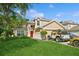 Two-story house with red door and well-maintained lawn at 5340 Plantation Home Way, Port Orange, FL 32128