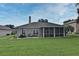 House exterior with screened patio and manicured lawn at 1322 Lucky Pennie Way, Apopka, FL 32712