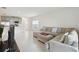 Living room with sectional sofa and view into kitchen at 1833 Ross Hammock Ave, Groveland, FL 34736