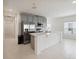 Open kitchen featuring stainless steel appliances and a large island at 1833 Ross Hammock Ave, Groveland, FL 34736