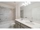 Bathroom with double vanity, large mirror, and bathtub at 1833 Ross Hammock Ave, Groveland, FL 34736