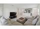 Living room with sectional sofa and kitchen view at 1833 Ross Hammock Ave, Groveland, FL 34736