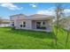 Newly constructed home with a backyard patio, grassy lawn and mature trees at 1833 Ross Hammock Ave, Groveland, FL 34736
