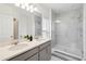 Bathroom with double vanity and large shower at 1833 Ross Hammock Ave, Groveland, FL 34736