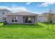 Private backyard with covered patio and grassy area at 1833 Ross Hammock Ave, Groveland, FL 34736